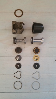 From the top: boot, piston and secondary seal, primary seal, valve assembly, valve seat, lock ring, valve seat